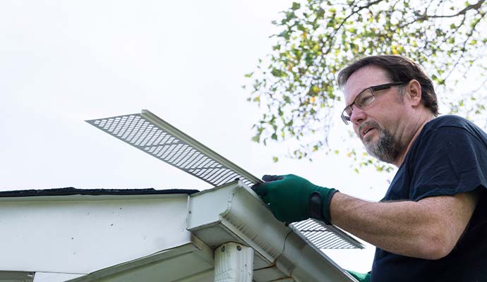 Person installing gutter guard