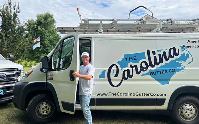 Chris Holding the Door of The Carolina Roofing and Gutter Company Vehicle