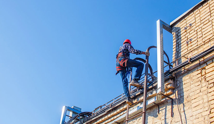 Worker restoring roof