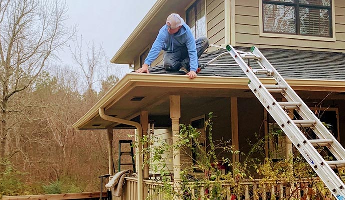 Expert inspecting gutter