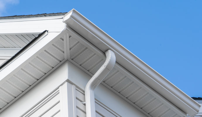 Clean and bright white gutters on a residential roofline