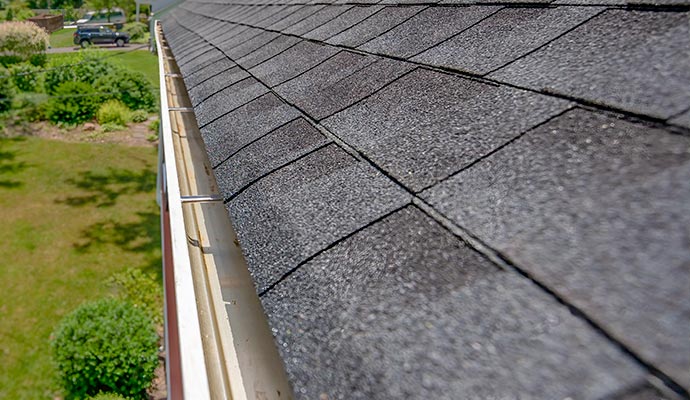 Clean and flushed gutter channel along a residential roofline