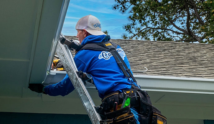 Person repairing gutter