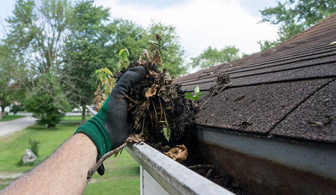 Cleaning clogged gutters by hand