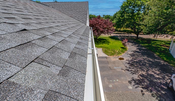 Freshly cleaned gutter system on house roof