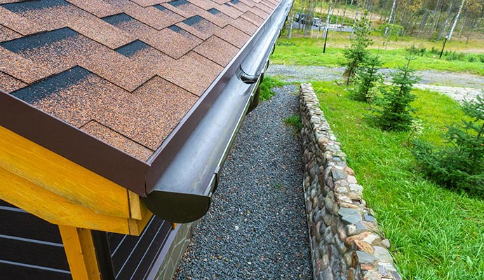 House roof with installed gutter system