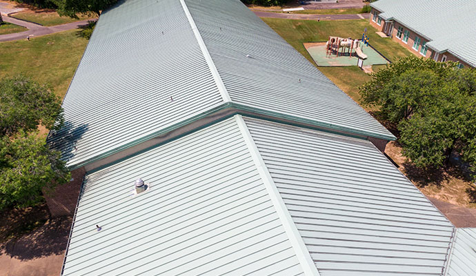 Large commercial metal roof installed on a commercial building