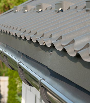 Metal gutter guard installed on house roof