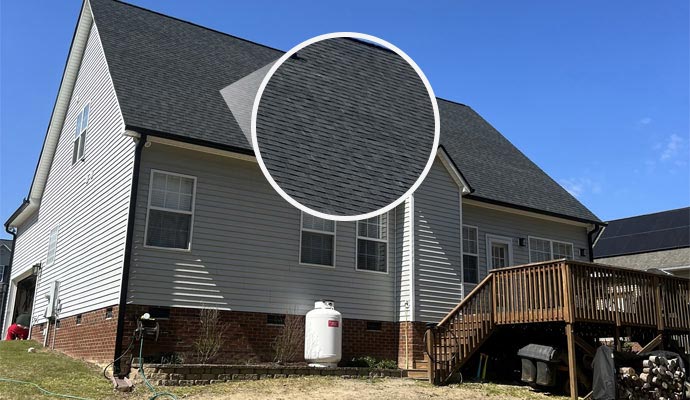 A residential home with an eco-friendly asphalt shingle roof highlighted to show recycled, durable roofing materials.