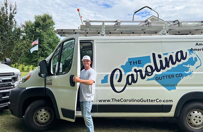 The Carolina Gutter service expert standing beside the service van