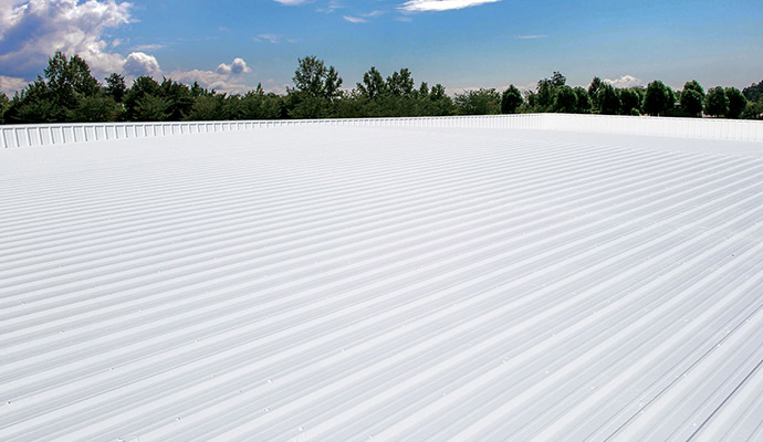 Worker installing metal roof